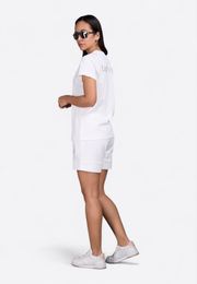 Model wearing ivory T-shirt, side pose – East Vibe